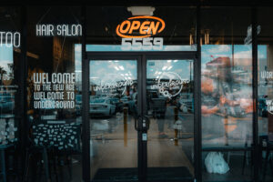 Night street view of Underground Barbershop entrance with neon logo and diverse crowd
